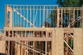 Wooden frame structure house building on a new development framing of under construction plywood plank wall Royalty Free Stock Photo