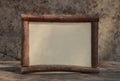 Rown wooden frame on the wooden tablewith stone background