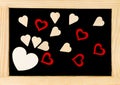 Wooden frame vintage chalkboard with red heart shape symbols Royalty Free Stock Photo