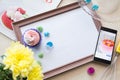 Wooden frame with a white sheet of paper lies on the table bleached oak, flatlay