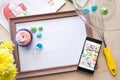 Wooden frame with a white sheet of paper lies on the table bleached oak, flatlay