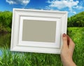 Wooden frame in woman hands. background of the creek in the forest Royalty Free Stock Photo