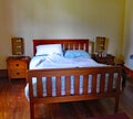 Wooden framed double bed in a quirky rental property in Masterton in New Zealand