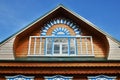 Wooden fretted roof with window on blue sky