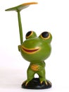 Wooden Frog holding a leaf Royalty Free Stock Photo