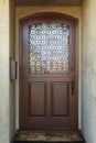 Wooden front door of home with ornate glass detail Royalty Free Stock Photo