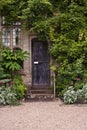 Wooden front door of old stone brick house Royalty Free Stock Photo