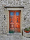 Wooden front door in an old stone wall