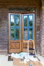 Wooden front door in the process of being refinished