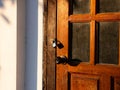 Wooden front door in a rustic wooden cottage. Rustic wooden cottage with locking door Royalty Free Stock Photo