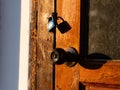 Wooden front door in a rustic wooden cottage. Rustic wooden cottage with locking door Royalty Free Stock Photo