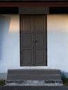 Wooden front door in a rustic wooden cottage. Rustic wooden cottage with locking door. Royalty Free Stock Photo