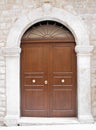 Wooden frontdoor with marble frame. Royalty Free Stock Photo