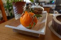 Wooden fruit bowl with orange and glass jar full of walnuts. Royalty Free Stock Photo