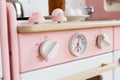 Wooden furniture for children. Play pink oven with thermometer and knobs