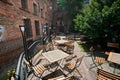 Wooden furniture of outdoor cafe without people at the gothic building