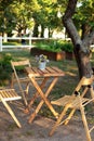 Wooden furniture set for Picnic in garden. Empty Wooden chairs and table on veranda of house.