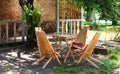 Wooden furniture set for Picnic in garden. Empty sun loungers and table on veranda of house in forest. outdoor furniture for leisu Royalty Free Stock Photo