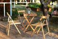 Wooden furniture set for Picnic in garden. Empty Wooden chairs and table on veranda of house. ÃÅ¾utdoor furniture for leisure time Royalty Free Stock Photo
