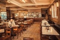 Wooden furniture and tiles floor in retro style restaurant, at bright day before lunch Royalty Free Stock Photo