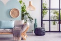 Wooden furniture and wicker accents in fashionable blue, green and white interior Royalty Free Stock Photo