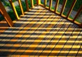 Wooden gallery with dramatic sunset shadows