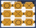 Wooden game tic tac toe on outdoor playground. Cross zero game noughts and crosses on a snowy ground. Tic tac toe winning Royalty Free Stock Photo