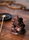 Wooden Ganesha Idol on the table with incense sticks