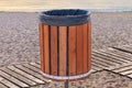 Wooden garbage can for rubbish on a sandy beach on a summer day Royalty Free Stock Photo