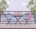 Wooden garden furniture on the balcony with wrought iron railings with a lilac pot with lavender flowers, matting mat.Cups of