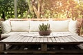 Wooden garden lounge chair with cushion and small cactus on the Royalty Free Stock Photo