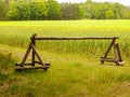 Wooden gate on country road between forest and rapeseed field Royalty Free Stock Photo