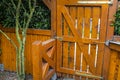 Wooden gate and fence on the back of the home garden. The gate is closed with a padlock. Royalty Free Stock Photo