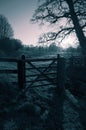 Wooden gate in a field meadow on a farm.