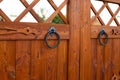 Wooden gate with metal ring handle for opening vintage doors Royalty Free Stock Photo