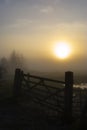 Wooden Gate and Misty Sunset Royalty Free Stock Photo