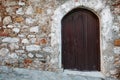 Wooden gate of an old castle made of stone with free space on the wall Royalty Free Stock Photo