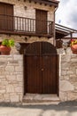 Wooden gate and stone fence in front of house in Cyprus Royalty Free Stock Photo