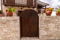 Wooden gate and stone fence in front of house in Cyprus Royalty Free Stock Photo