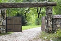 The wooden gate in a stone wall on a monastery. Retro countryside wooden gate with with stone wall in vintage style. Peaceful