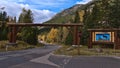 Wooden gate and welcome sign at the southern entrance of popular Bow Valley Parkway in Banff National Park, Rocky Mountains.