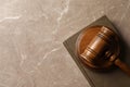 Wooden gavel and book on table, top view. Royalty Free Stock Photo