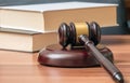 Wooden gavel and books in background. Law and justice concept Royalty Free Stock Photo