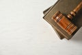 Wooden gavel and books on light table, top view Royalty Free Stock Photo