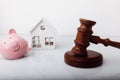 Wooden gavel, broken piggy bank and house model isolated on white. Auction and bankruptcy concept Royalty Free Stock Photo