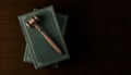 Wooden gavel, judges hammer or mallet on books over wood table background, law, legal or court symbol or concept, top view flat Royalty Free Stock Photo