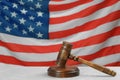 Wooden gavel on light grey table against American flag. Space for text Royalty Free Stock Photo