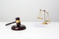 Wooden gavel put on white desk table.