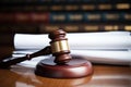 a wooden gavel resting on a pile of legal papers