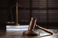 Wooden gavel, scales of justice and books on table against blurred background Royalty Free Stock Photo